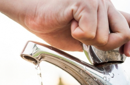 mano masculina cerrando un grifo