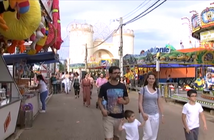 Familia paseando por el recinto ferial durante la Feria de San Juan de Badajoz