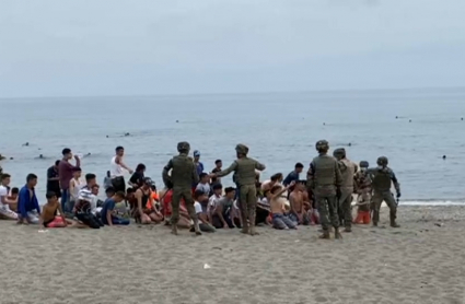 Menores llegados a Ceuta son agrupados en la playa del Tarajal.